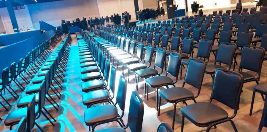Congress hall with rows of chairs under stage lighting